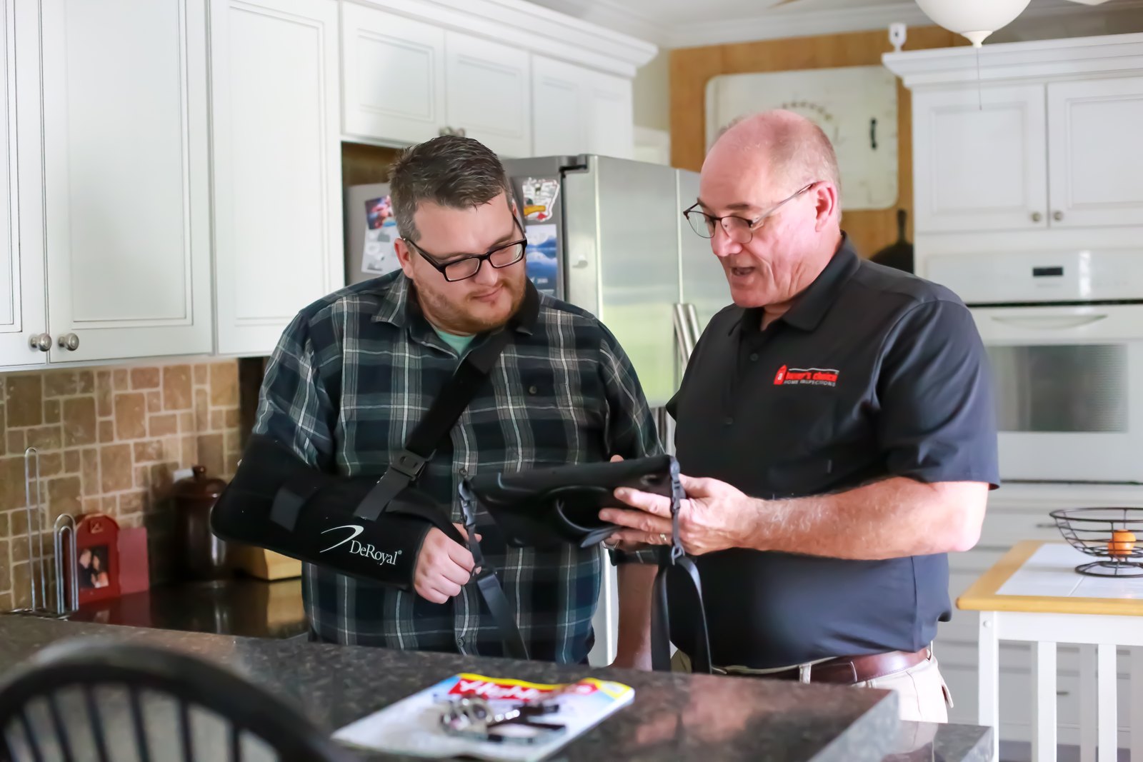 Joseph Caruso inspecting a property in a black ABCHI shirt