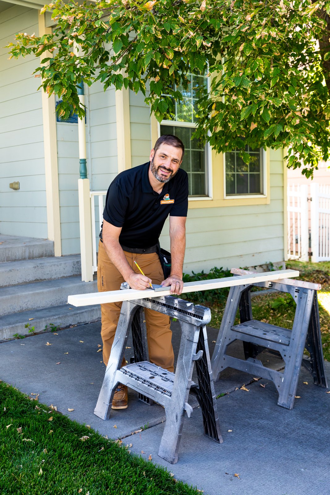 Service professional in a black shirt working outside a home