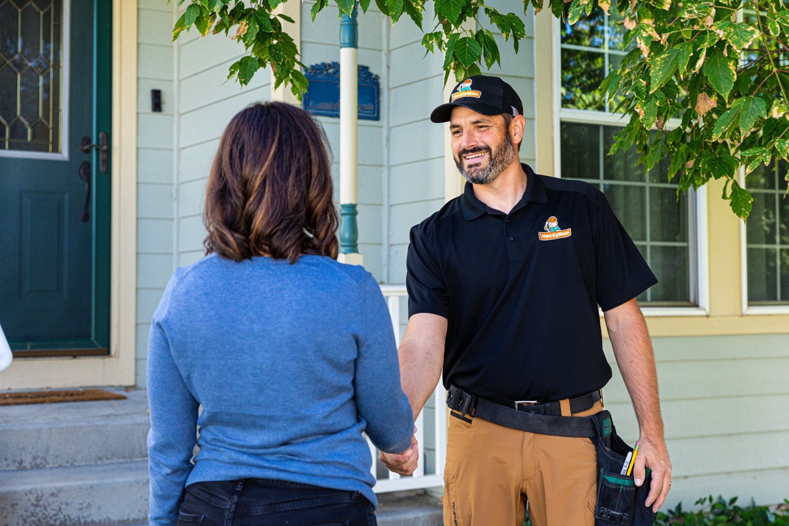 Service professional in a black shirt speaking with a customer
